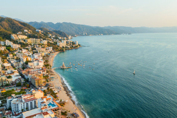 Los Muertos beach area under the light of the golden hour in Puerto Vallarta, Mexico destinos de playa en México